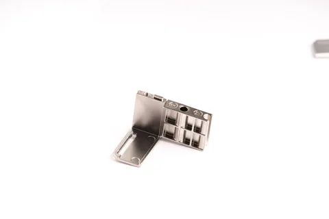 Compact metal connector component for a sensor-related assembly